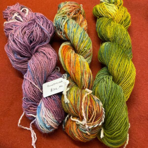 Multi-colored purple, yellow, and green hand painted fingering weight Alpaca yarn